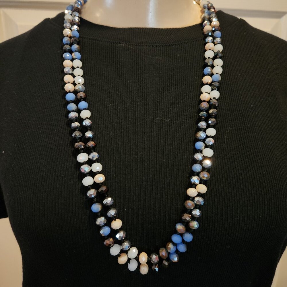 Multi-strand beaded necklace with black, white, and blue faceted beads